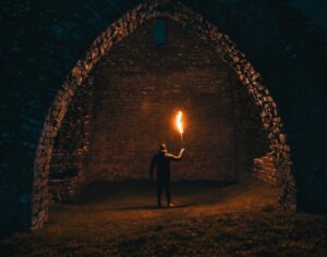 person holding torch in building interior